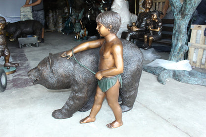 A bear with a boy bronze statue -  Size: 39"L x 24"W x 32"H.
