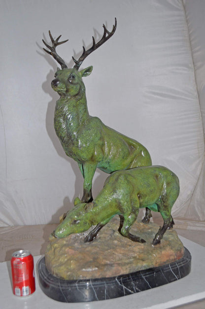 Two Deers Bronze Statue with a Green patina finish - Size: 15"L x 22"W x 32"H.
