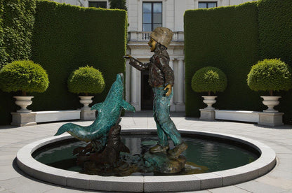 Girl feeding a dolphin and seals bronze fountain -  Size: 28"L x 17"W x 37"H.
