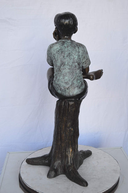 Boy Sitting on a Stump Reading a Book -  Size: 18"L x 20"W x 35"H.