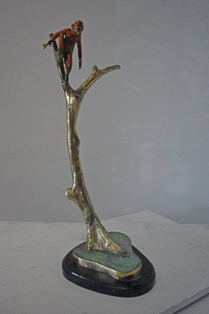 Colored Monkey Resting on a Tree Bronze Statue - Size: 12"L x 13"W x 27"H.