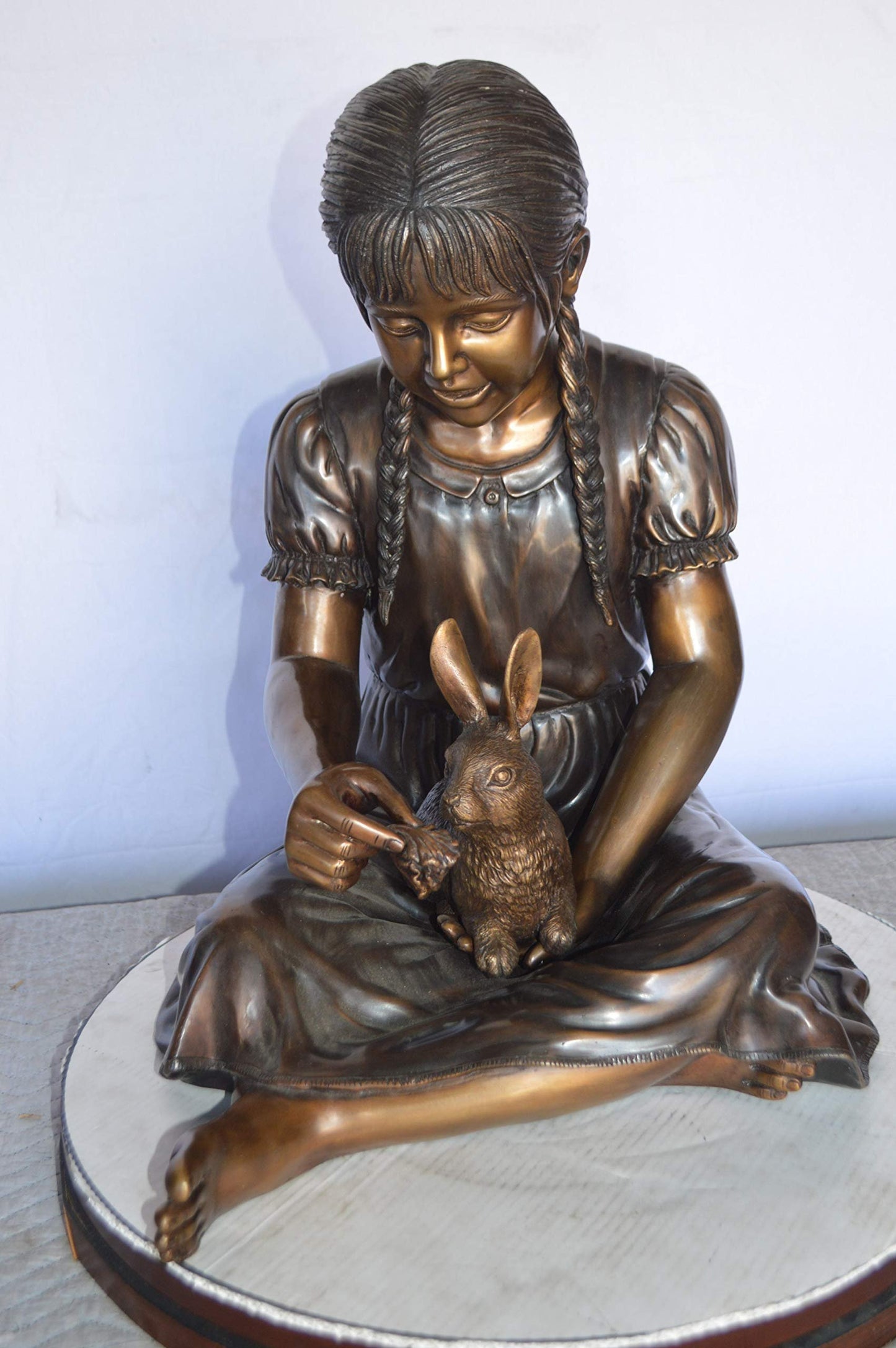 Sandra Sitting With Her Rabbit Bronze Statue -  Size: 25"L x 18"W x 25"H.