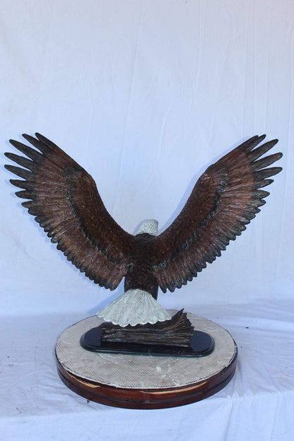 Perched eagle bronze statue -  Size: 35"L x 21"W x 29"H.