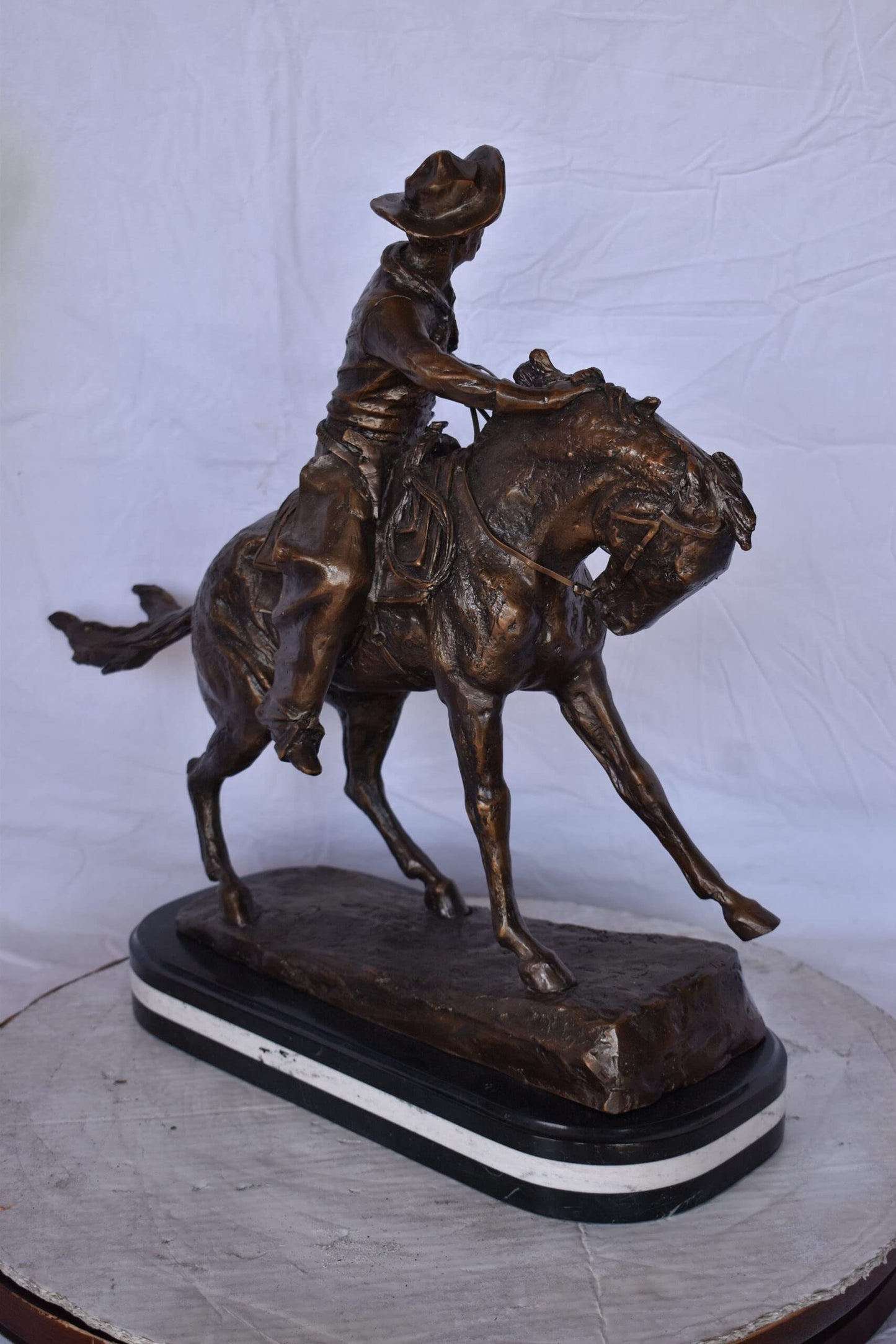 Remington Cowboy Replica Bronze Statue on Triple Marble - Size: 8"x 26"x 23"H.