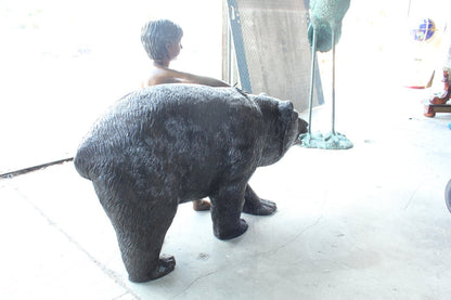 A bear with a boy bronze statue -  Size: 39"L x 24"W x 32"H.