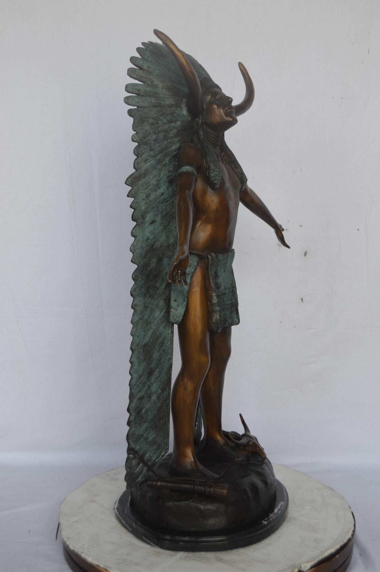 Indian with Plume bronze statue - Size: 22"L x 14"W x 38"H.