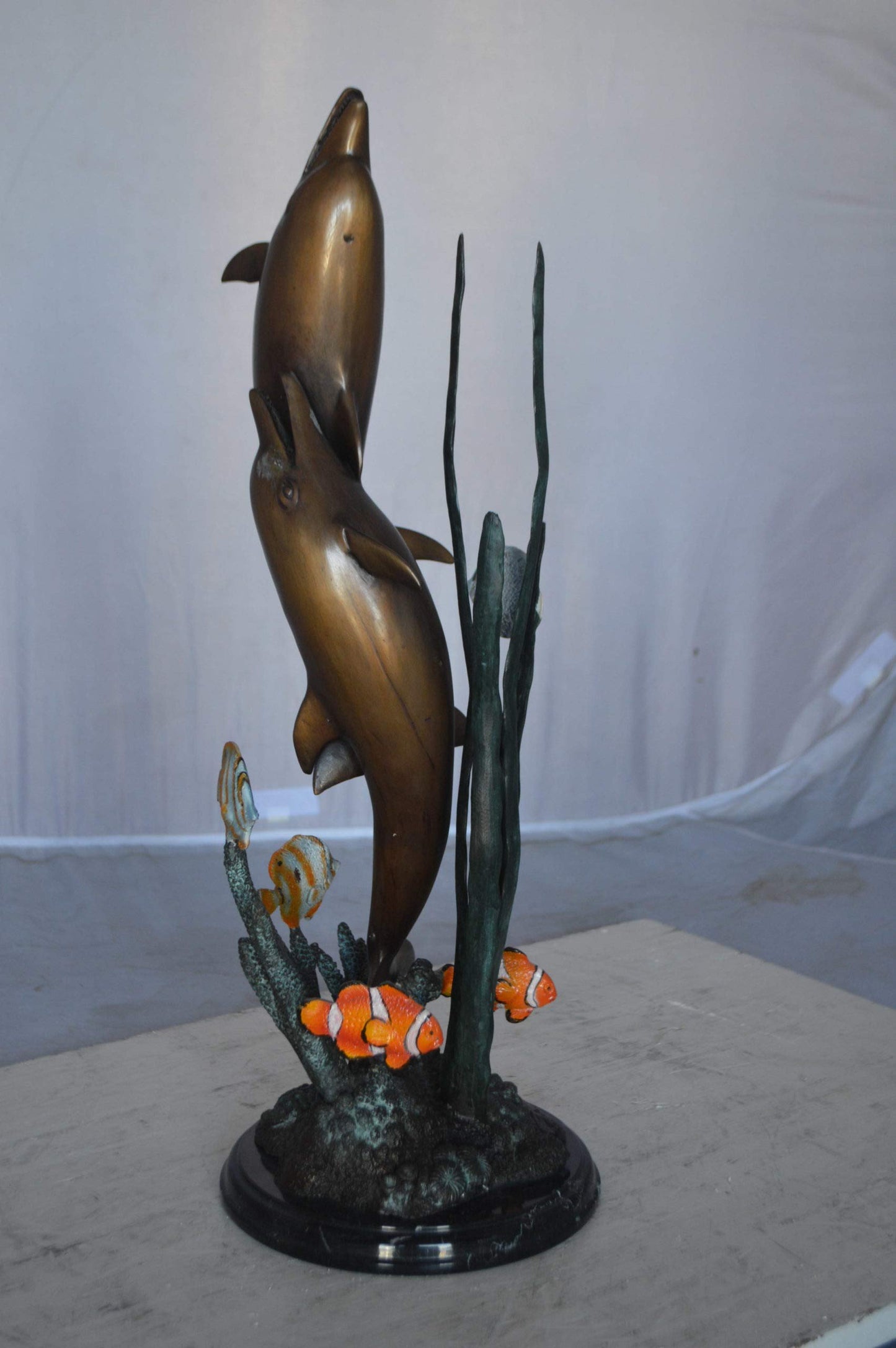 Two dolphins with fish, table top bronze statue. -  Size: 8"L x 8"W x 22"H.