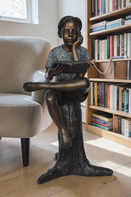 Boy Sitting on a Stump Reading a Book -  Size: 18"L x 20"W x 35"H.