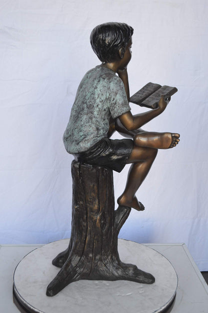 Boy Sitting on a Stump Reading a Book -  Size: 18"L x 20"W x 35"H.