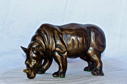 Relaxed Rhino bronze statue -  Size: 16"L x 9"W x 8"H.
