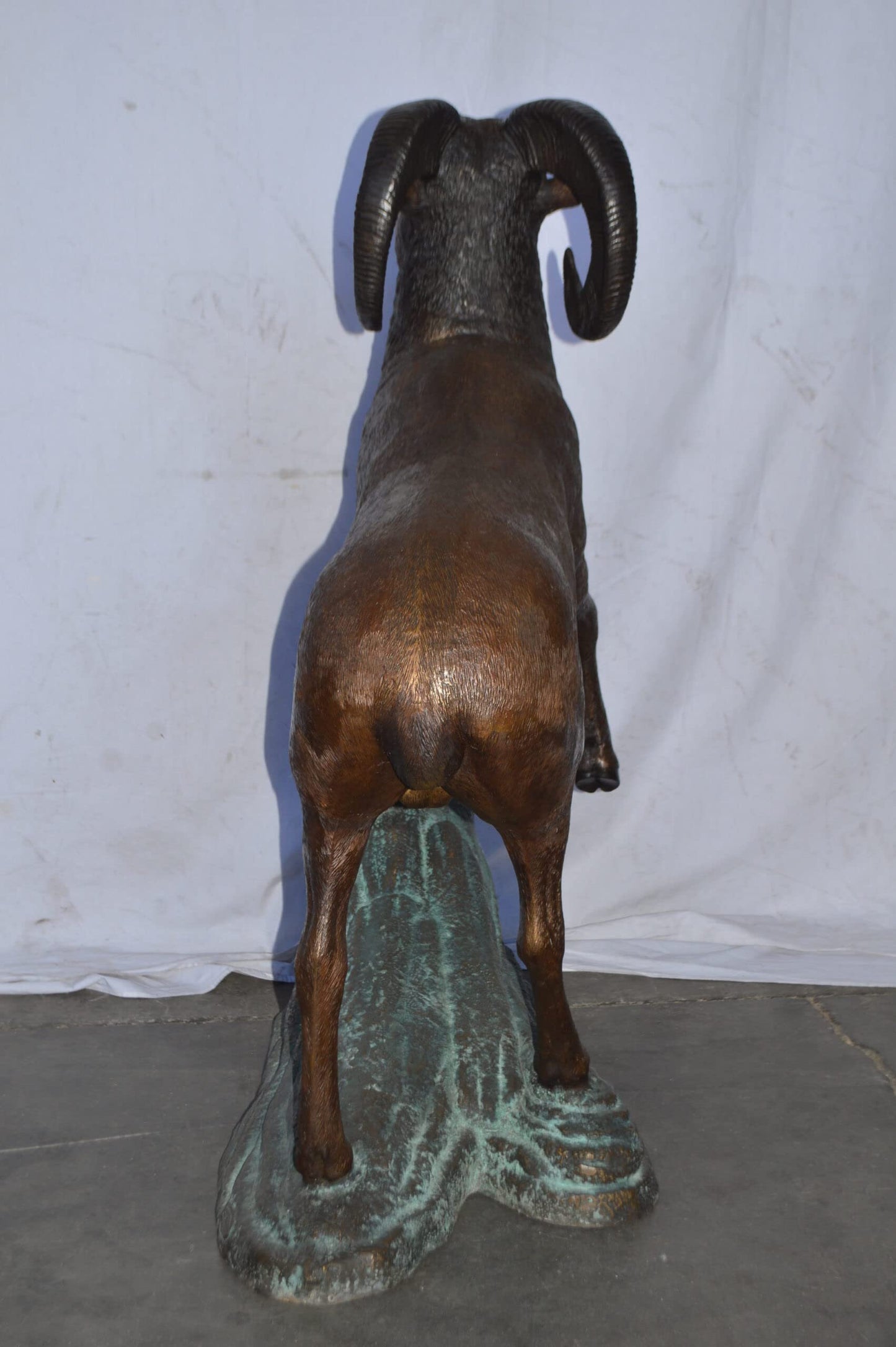 Life Size Ram standing on a rock Bronze Statue - Size: 38"L x 19"W x 45"H.