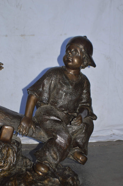 A Boy and a Girl Playing Seesaw Bronze Statue - Size: 17"L x 33"W x 36"H.
