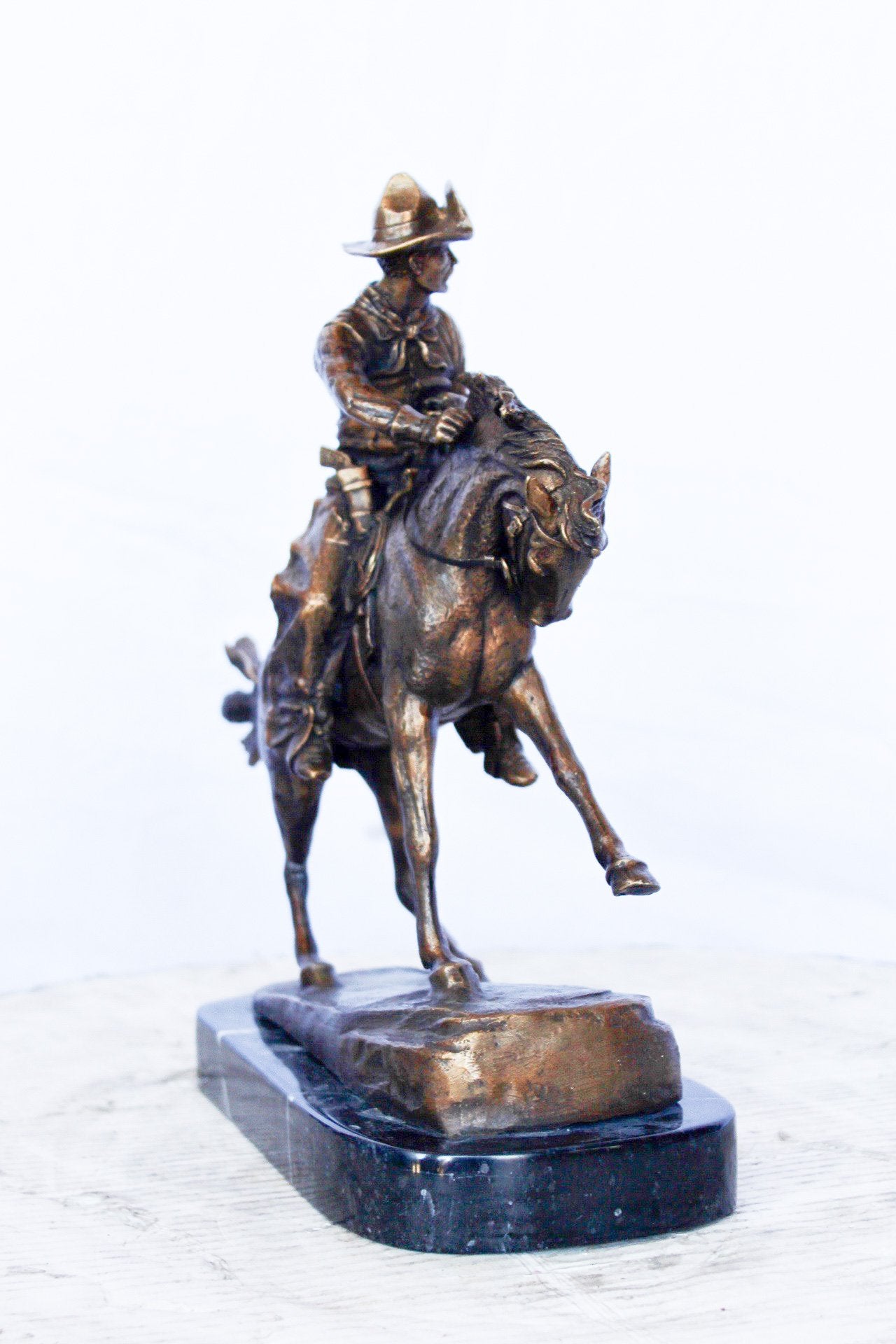 Remington replica Cowboy bronze statue -  Size: 5"L x 15"W x 13"H.