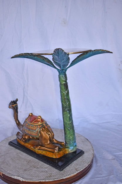 Camel Sitting Under A Palm Tree Bronze Statue - Size: 17"L x 27"W x 23"H.