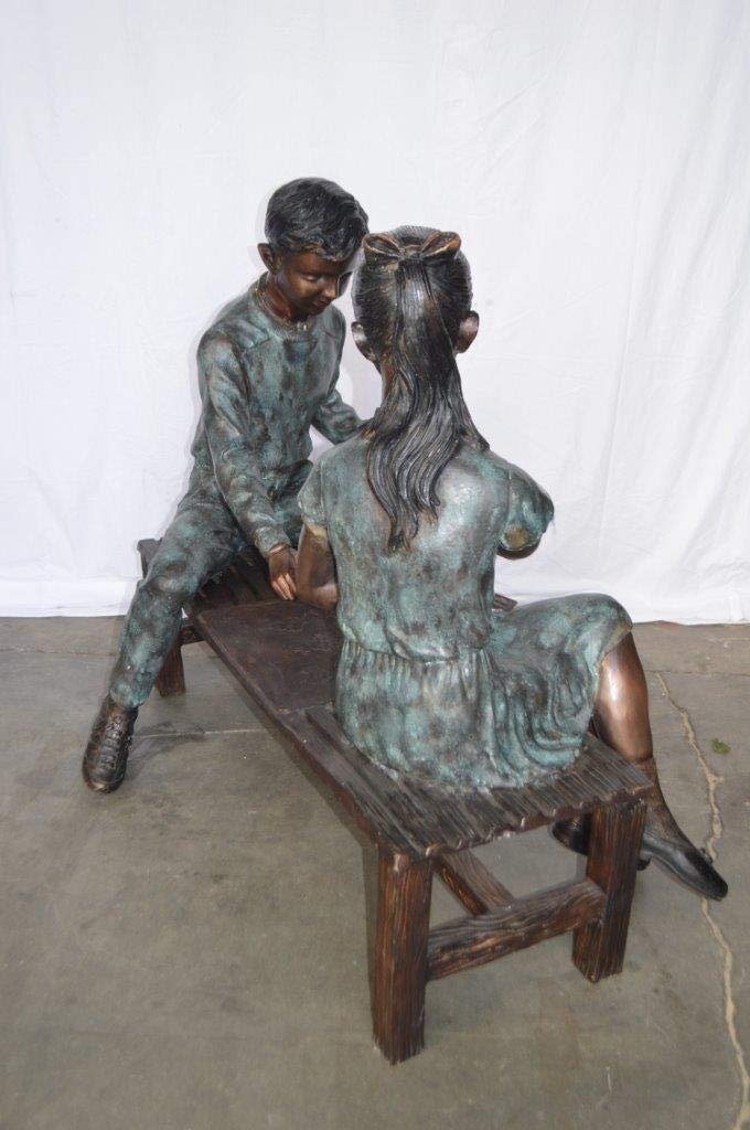 Young Couple Reviewing a World Map Bronze Statue -  Size: 32"L x 47"W x 42"H.