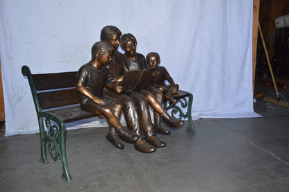 Mom and boys reading stories on bench bronze statue - Size: 53"L x 33"W x 39"H.