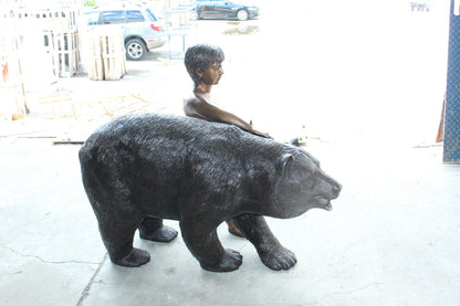 A bear with a boy bronze statue -  Size: 39"L x 24"W x 32"H.