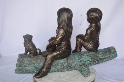 Young children and dog on a log bronze statue - Size: 40"L x 16"W x 24"H.