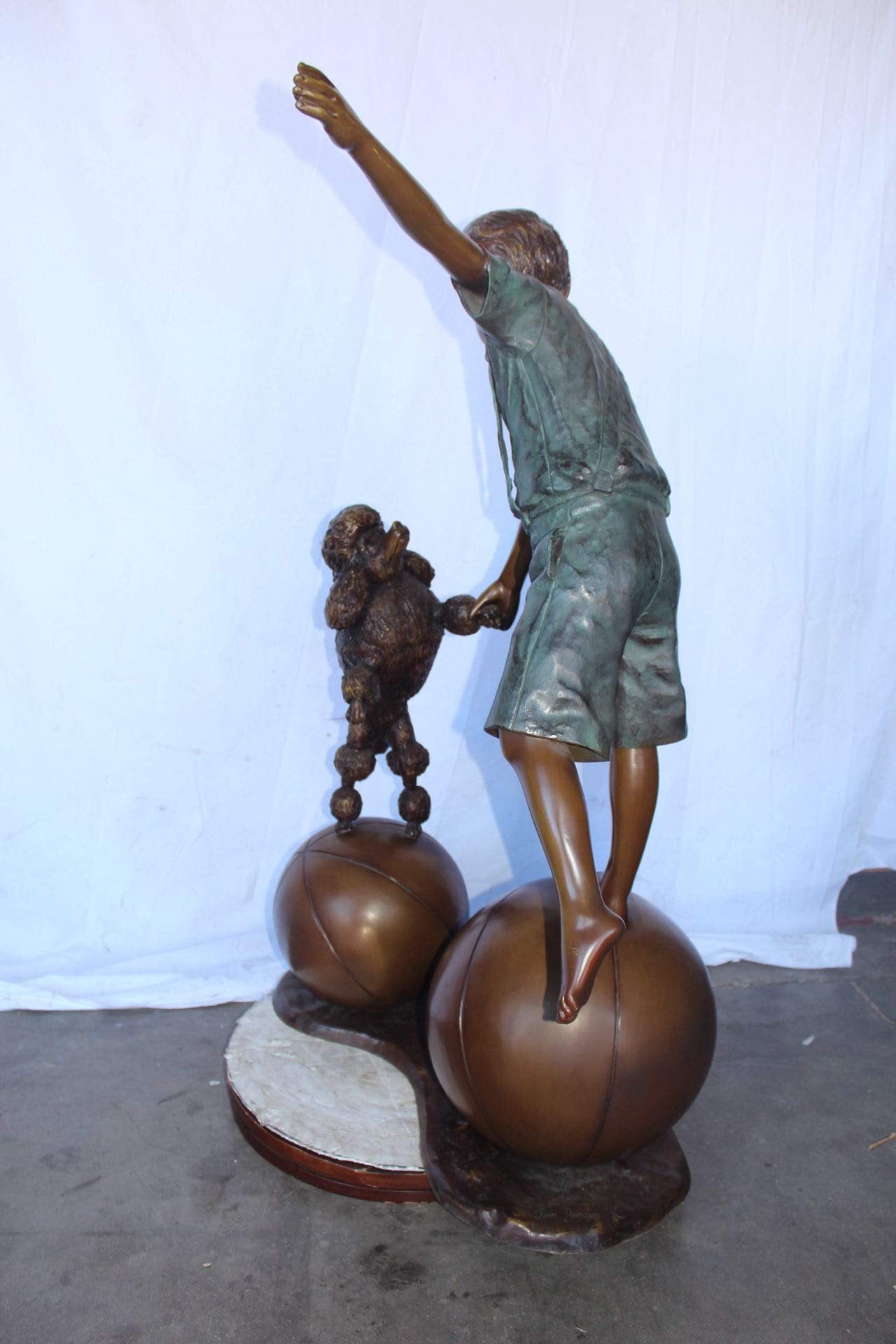 Boy and poodle balancing circus stars bronze statue -  Size: 38" x 27" x 55"H.