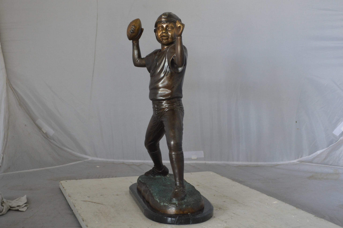 Young Quarterback bronze statue - Size: 14"L x 6"W x 20"H.