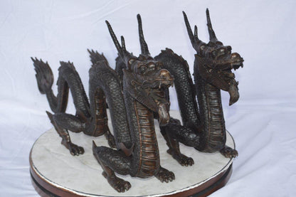 Pair of Dragons sitting side by side bronze statues -  Size: 31"L x 7"W x 16"H.