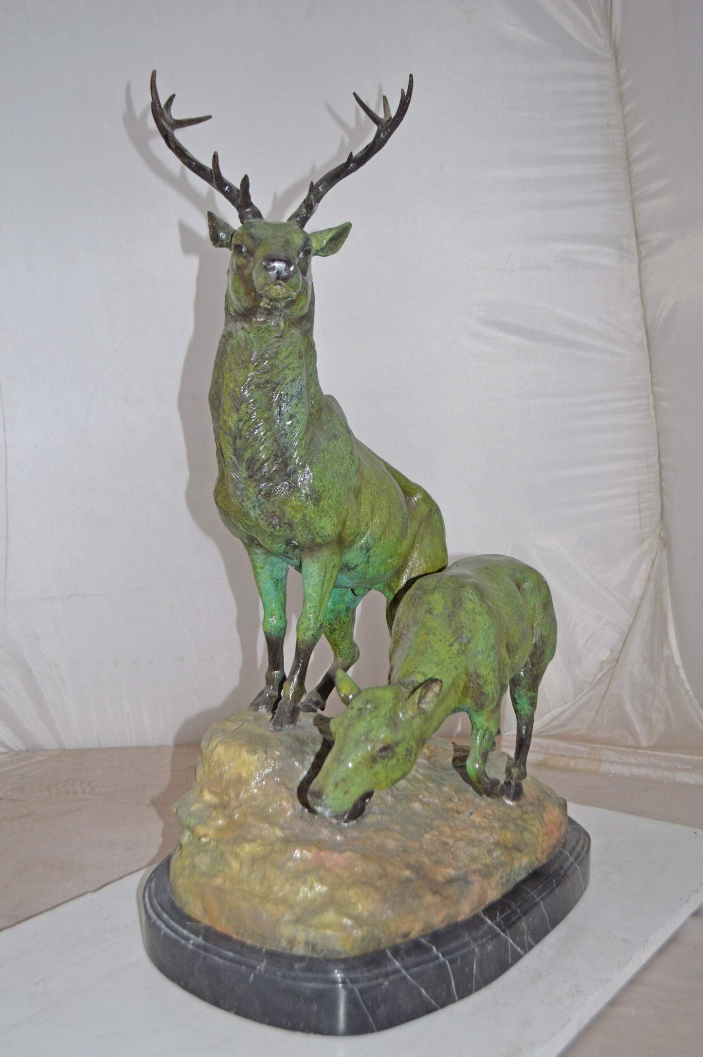 Two Deers Bronze Statue with a Green patina finish - Size: 15"L x 22"W x 32"H.
