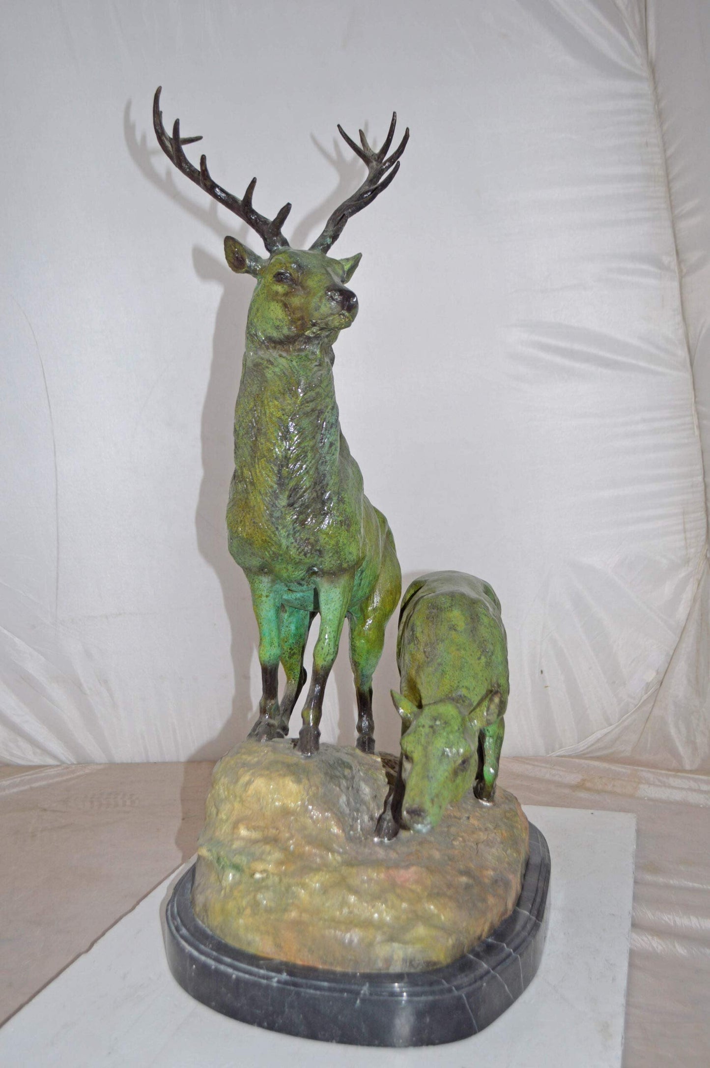 Two Deers Bronze Statue with a Green patina finish - Size: 15"L x 22"W x 32"H.