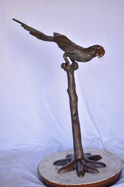 Parrot on a Tree looking Down Bronze Statue - Size: 37"L x 15"W x 47"H.