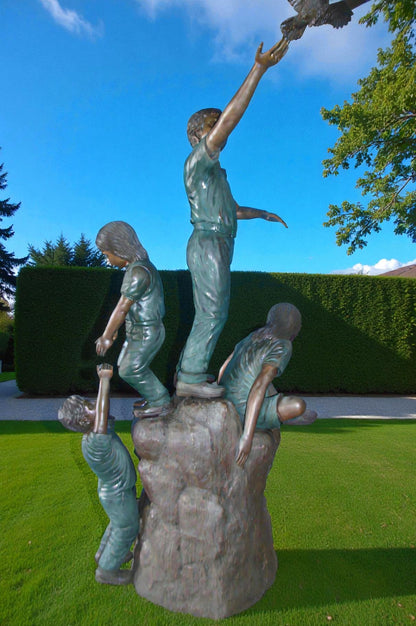 Four Kids Playing on a Rock Bronze Statue -  Size: 49"L x 26"W x 89"H.