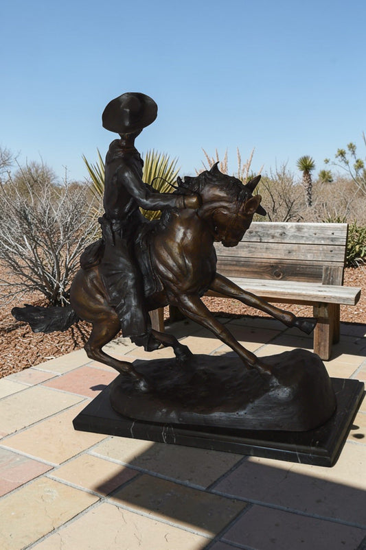 Remington Cowboy on marble Bronze Statue -  Size: 24"L x 9"W x 23"H.