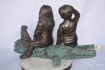 Young children and dog on a log bronze statue - Size: 40"L x 16"W x 24"H.