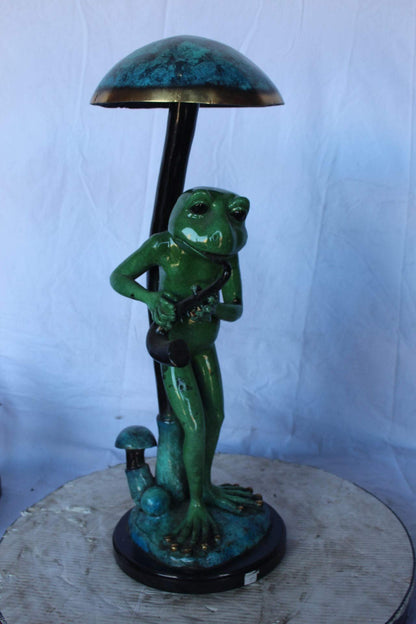 Jazzy frog perched under mushroom bronze statue   -  Size: 10"L x 10"W x 28"H.