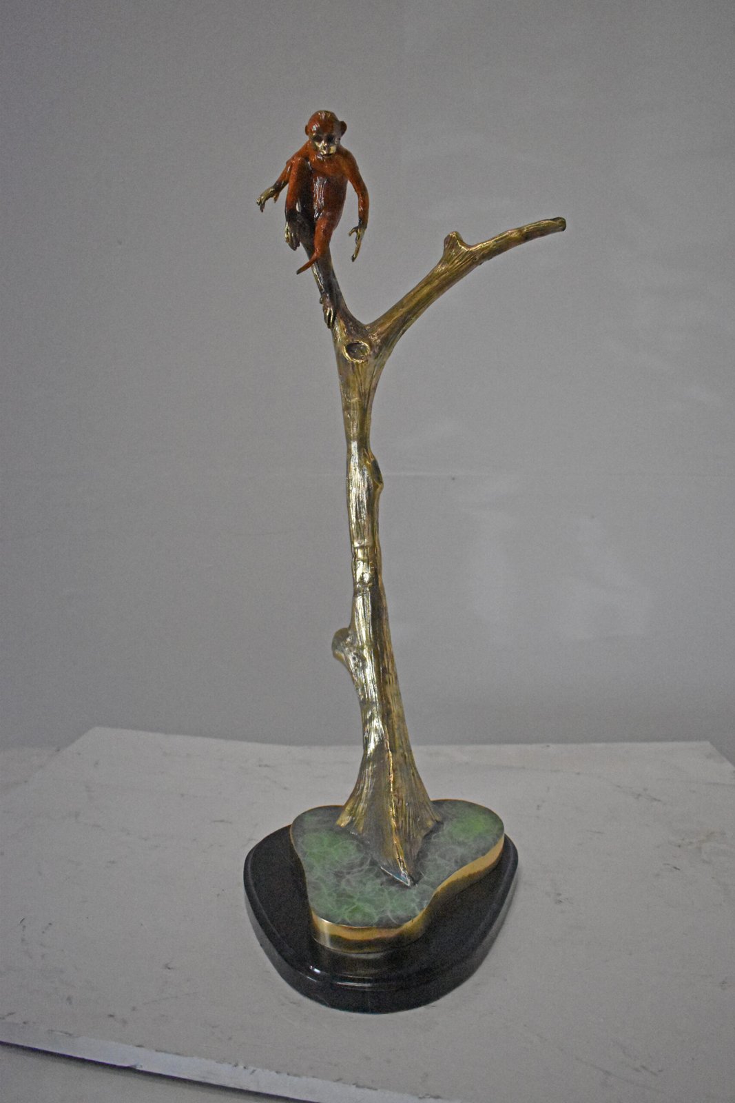Colored Monkey Resting on a Tree Bronze Statue - Size: 12"L x 13"W x 27"H.