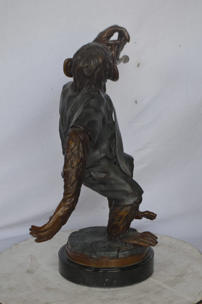 Monkey With Trumpet Bronze Statue - Size: 24"L x 12"W x 26"H.