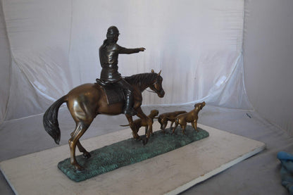 Hunter with three dogs Bronze Statue -  Size: 27"L x 6"W x 18"H.