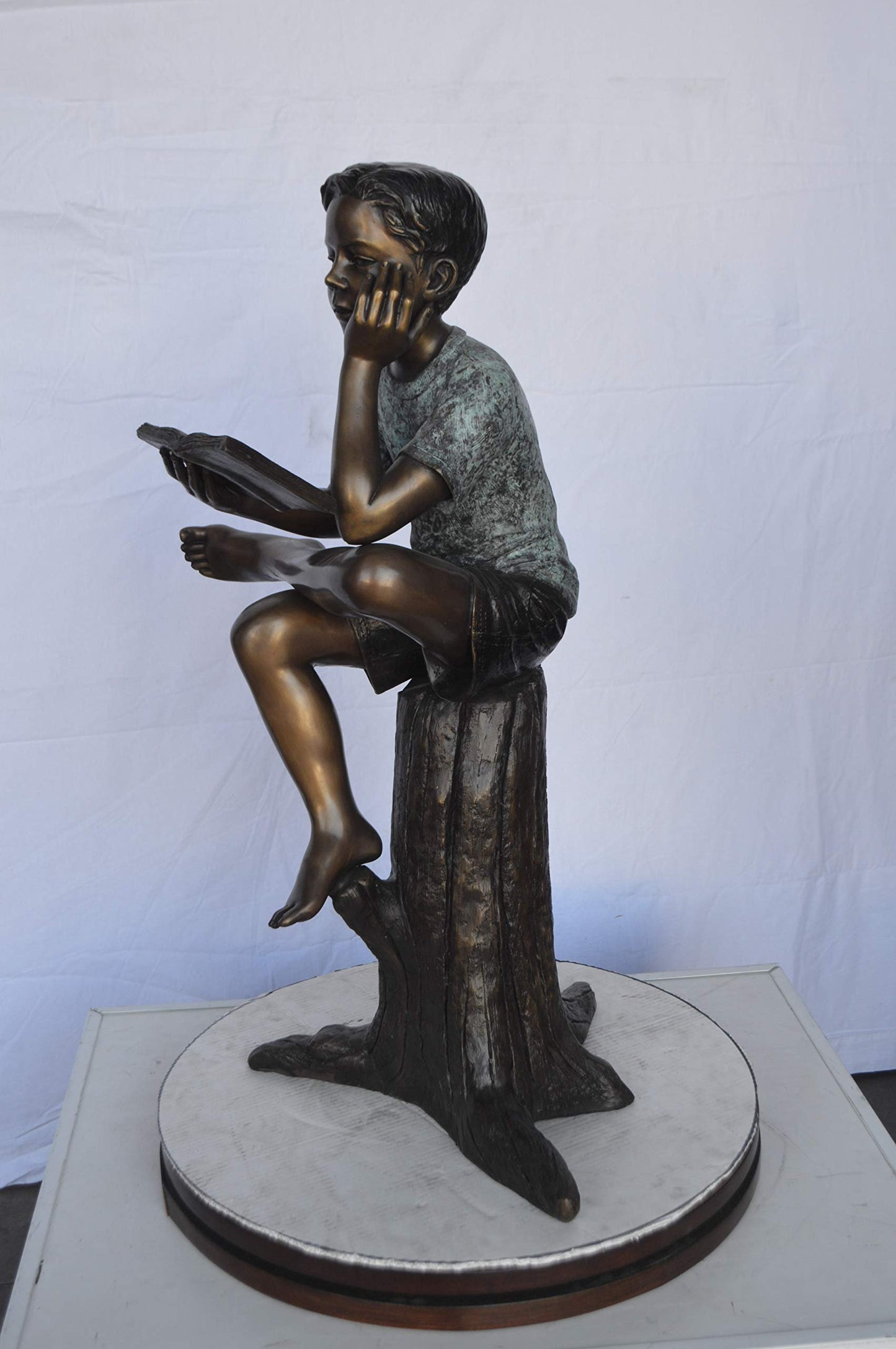Boy Sitting on a Stump Reading a Book -  Size: 18"L x 20"W x 35"H.
