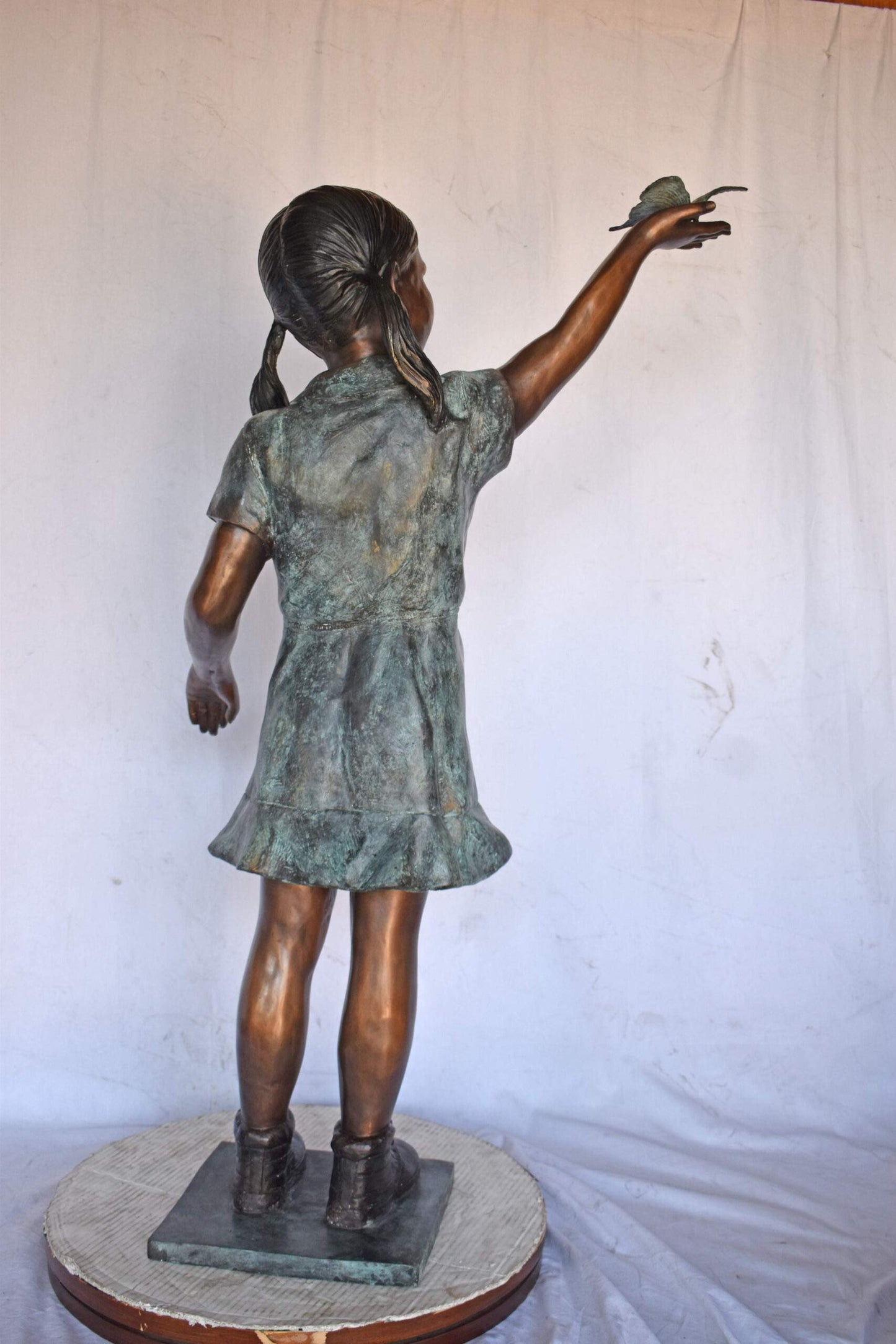 Young Girl Holding a Butterfly Outside at The Park - Size: 21"L x 11"W x 49"H