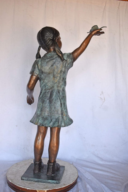 Young Girl Holding a Butterfly Outside at The Park - Size: 21"L x 11"W x 49"H