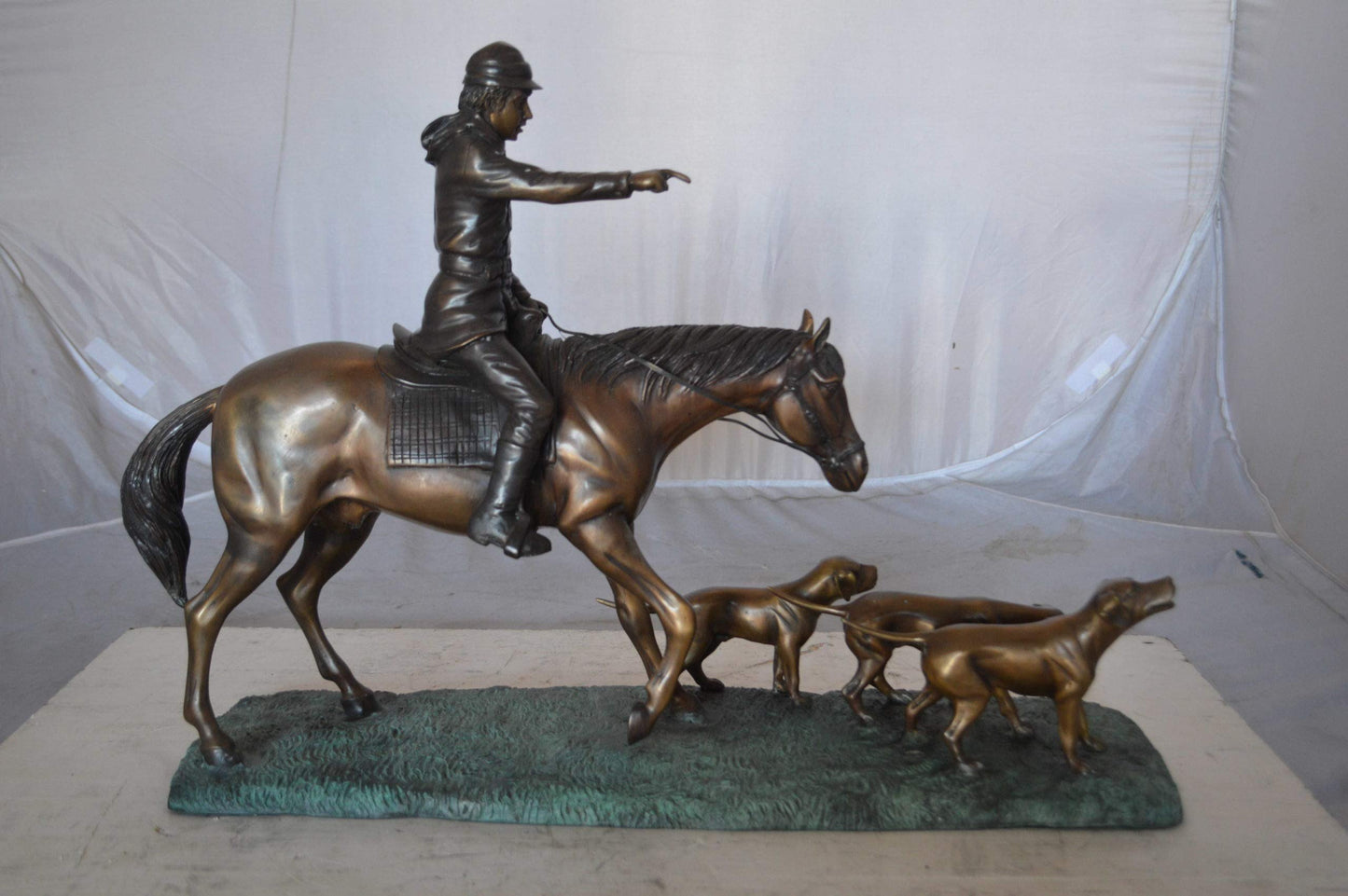Hunter with three dogs Bronze Statue -  Size: 27"L x 6"W x 18"H.