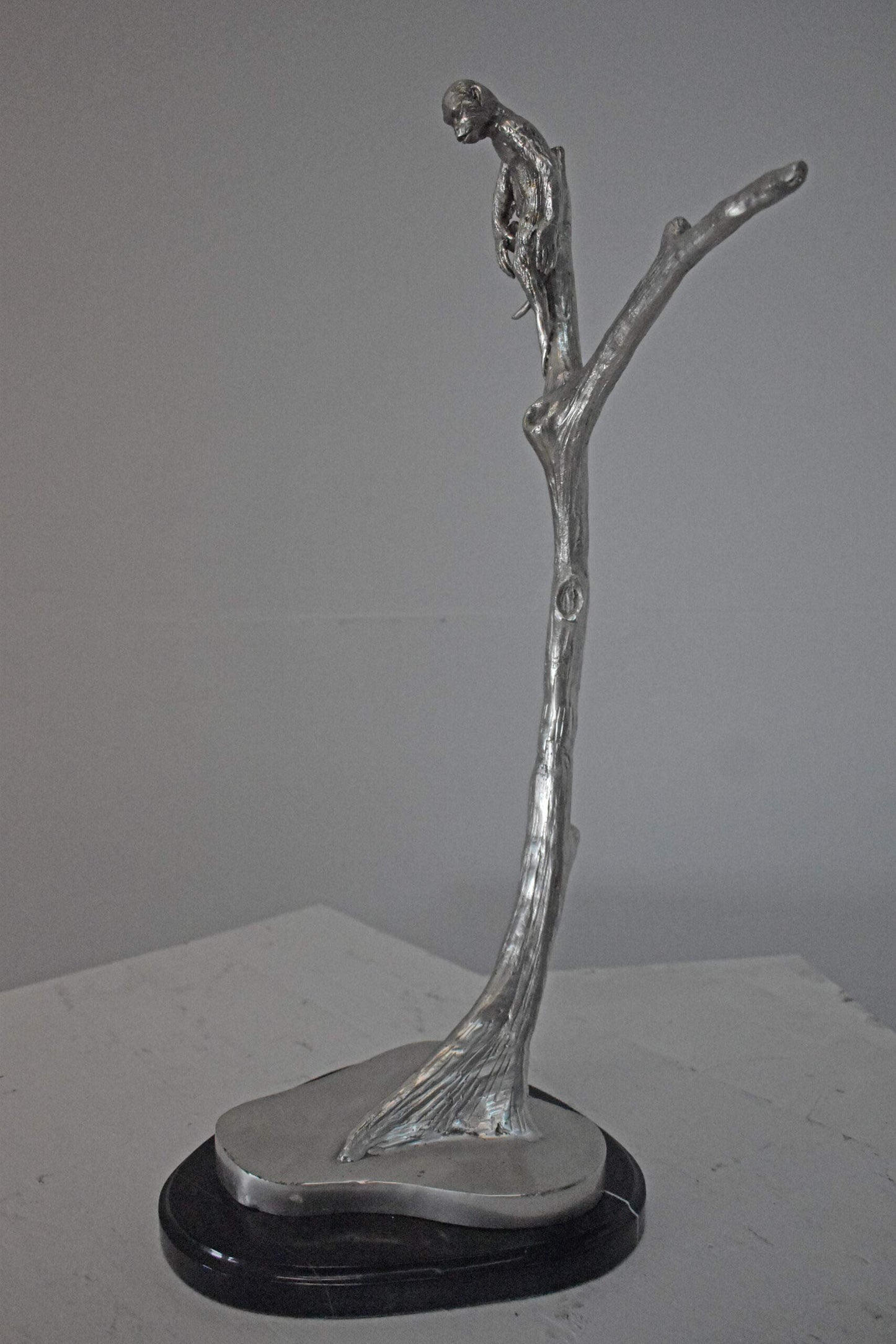Monkey Resting on a Tree Silver Finish Bronze Statue - Size: 12" x 13" x 27"H.