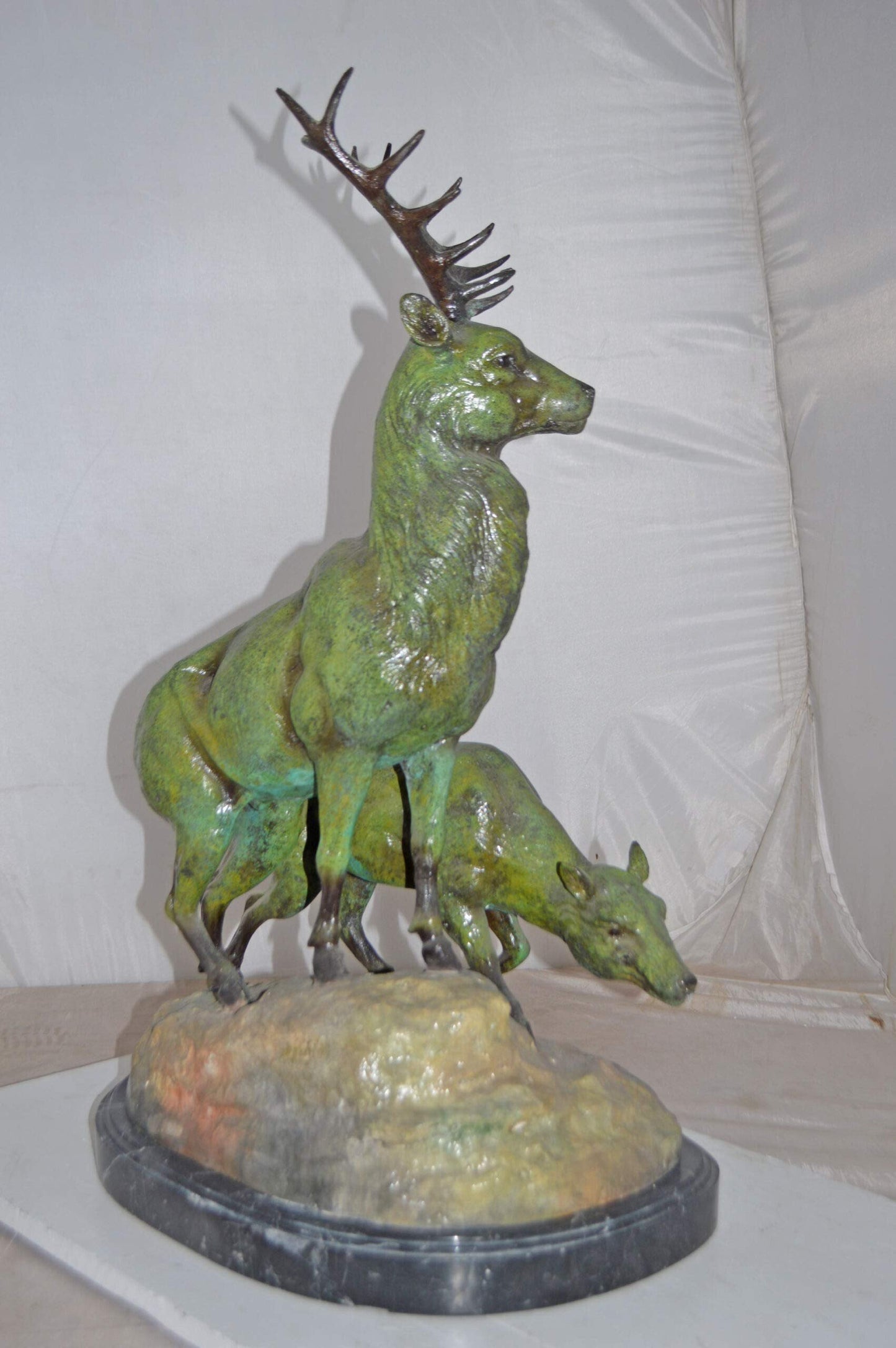 Two Deers Bronze Statue with a Green patina finish - Size: 15"L x 22"W x 32"H.