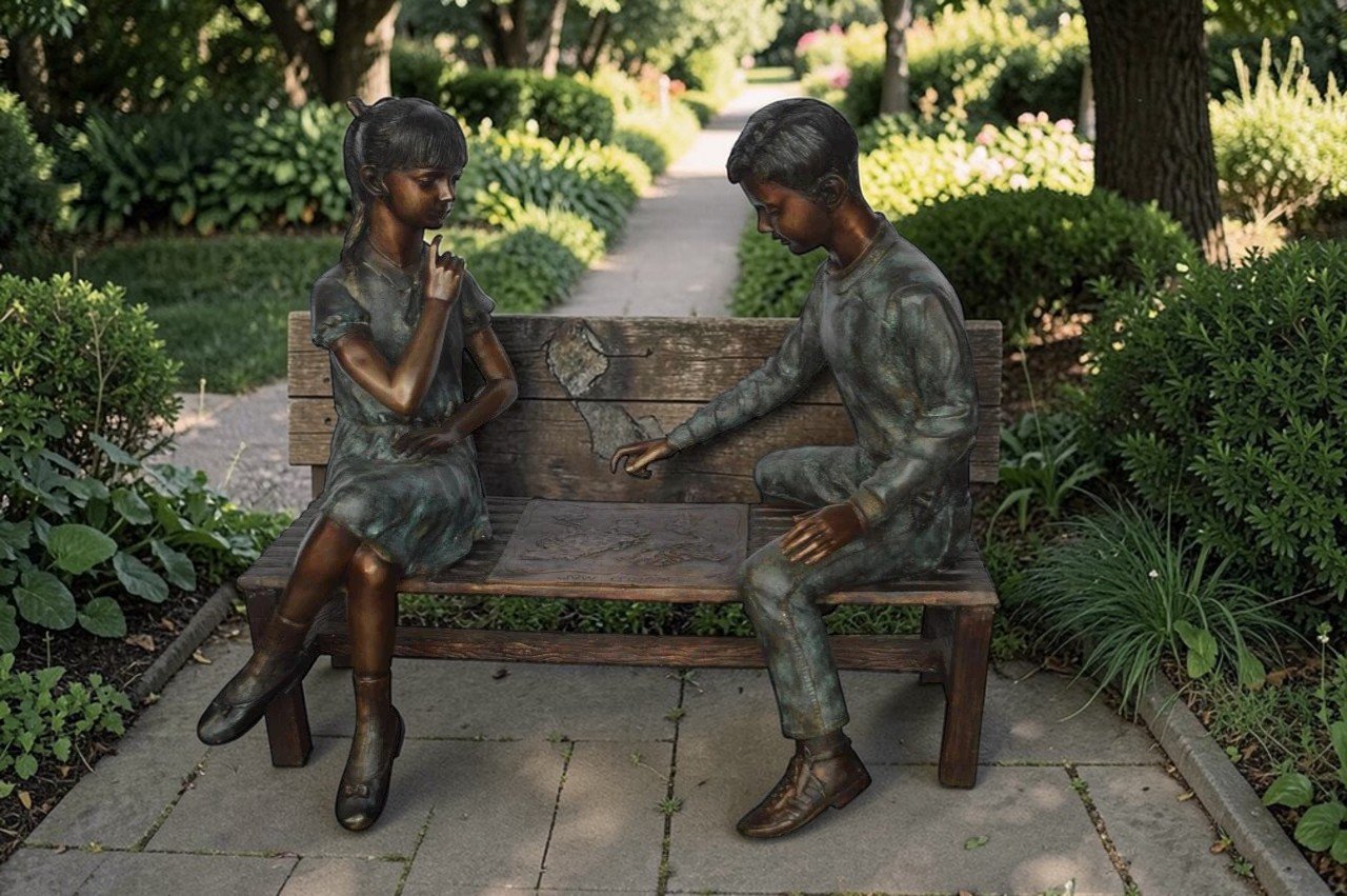 Young Couple Reviewing a World Map Bronze Statue -  Size: 32"L x 47"W x 42"H.