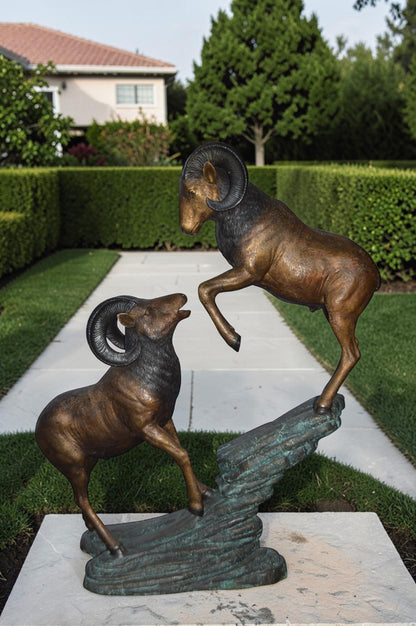 Two Life Size Rams on a rock Bronze Statue - Size: 49"L x 20"W x 64"H.