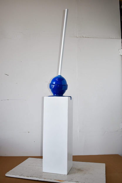 Blue Lollipop Mounted on A White Pedestal Resin Statue Size: 10" x 10" x 59"H