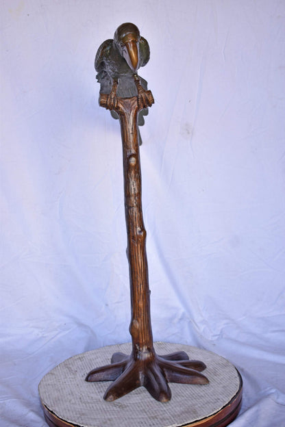Parrot on a Tree Watching Forward Bronze Statue - Size: 36"L x 15"W x 41"H.