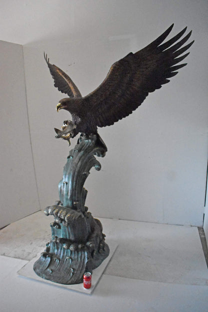 Eagle in Action Catching His Prey Bronze Statue - Size: 68"L x 40"W x 87"H.