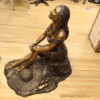 Lady on Stone Bronze Statue -  Size: 33"L x 23"W x 34"H.