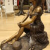 Lady on Stone Bronze Statue -  Size: 33"L x 23"W x 34"H.