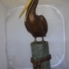 Pelican on a Stump Bronze Statue -  Size: 14"L x 38"W x 58"H.