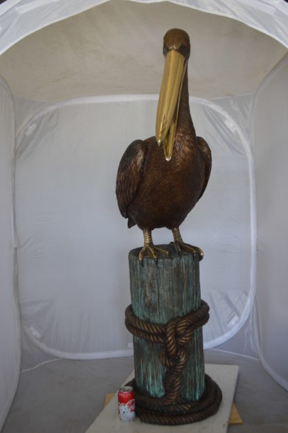 Pelican on a Stump Bronze Statue -  Size: 14"L x 38"W x 58"H.